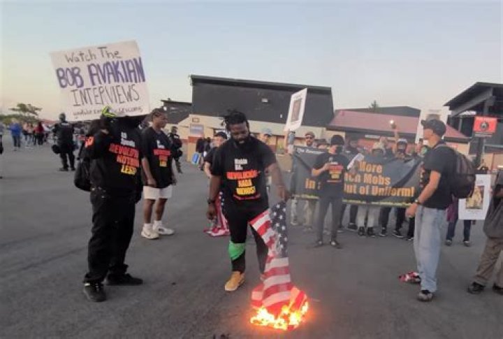 Communist revolutionaries burn American flags in protest outside Jason Aldean concert in Chicago