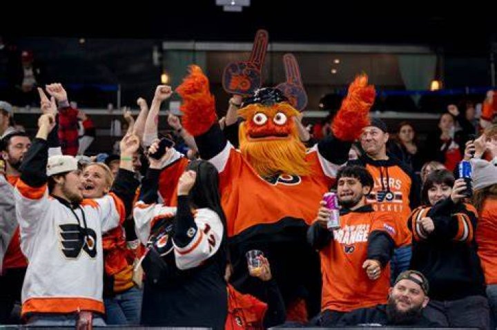 Flyers mascot Gritty dances with support alligator during game
