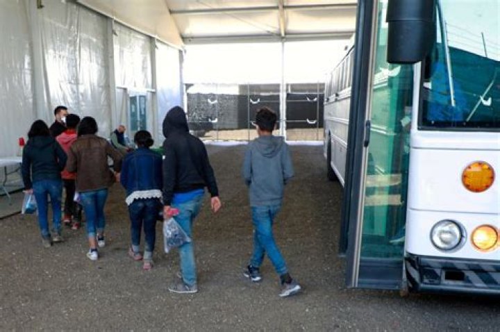 Migrants wait outside El Paso bus station for free trips to NYC and Chicago