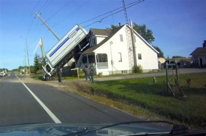 Penske truck on house removed after bizarre crash