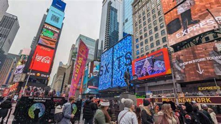Polyamorous OnlyFans couple buys billboard in NYC's Times Square