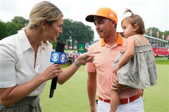 Rickie Fowler embraces wife Allison Stokke after Rocket Mortgage Classic