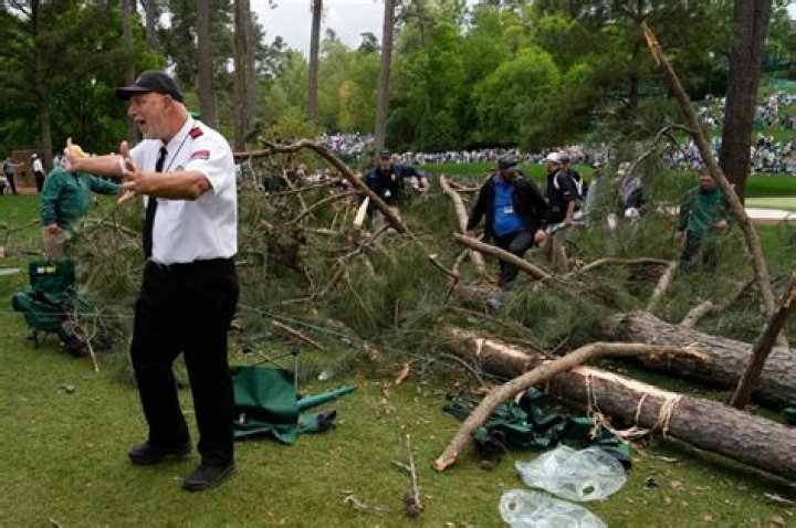 Spectators dive for safety as tree falls at Masters during violent storm